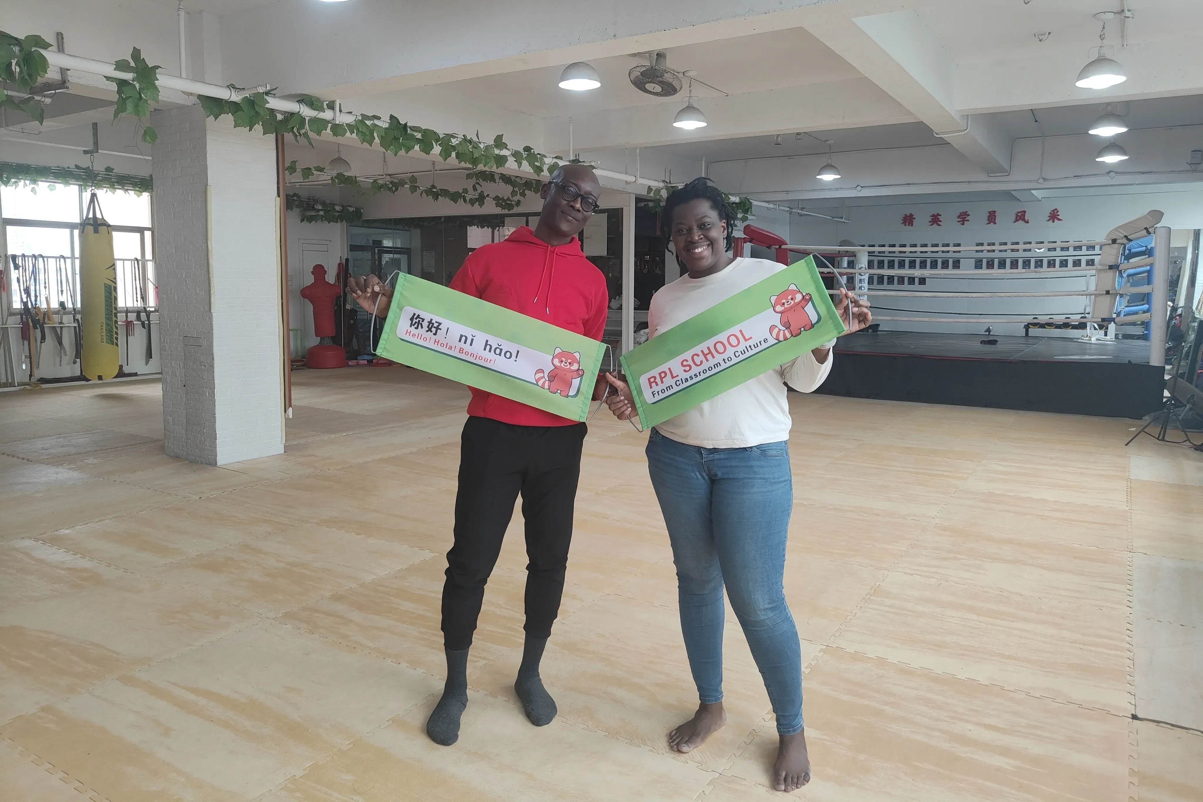 Students learning Chinese kung fu warm-up exercises and flexibility training, demonstrating proper stretching techniques and preparation for martial arts practice, showing the importance of physical conditioning in traditional Chinese martial arts.